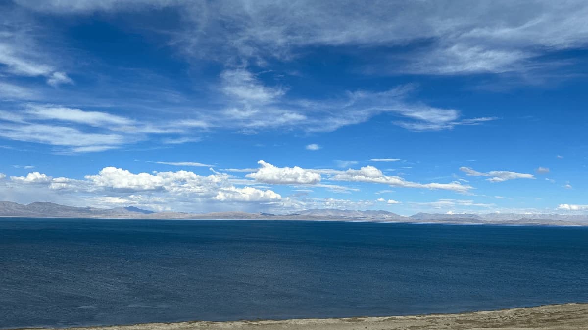 Snow-capped Mount Kailash glowing under a clear blue sky, viewed during the Kailash Mansarovar Yatra.